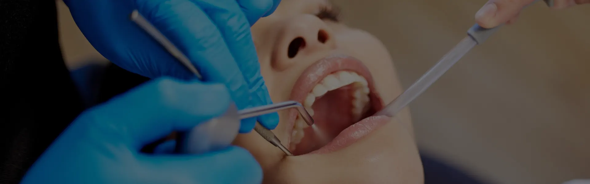 Dentist examining a patient’s teeth with a mirror and probe